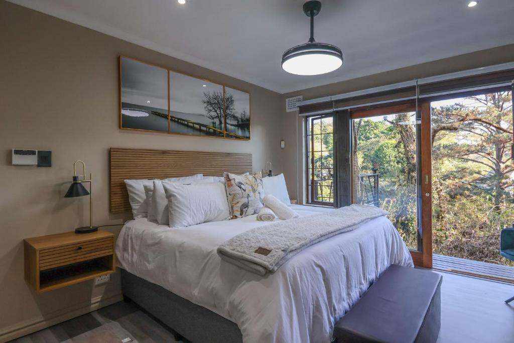 a bedroom with a large bed and a window at Cornerstone Connection in Durban