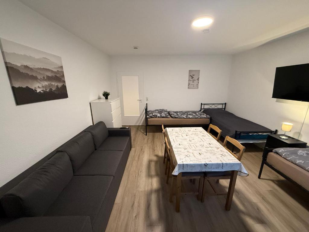 a living room with a couch and a table at Cosy, beautiful and central apartment in Karlsruhe