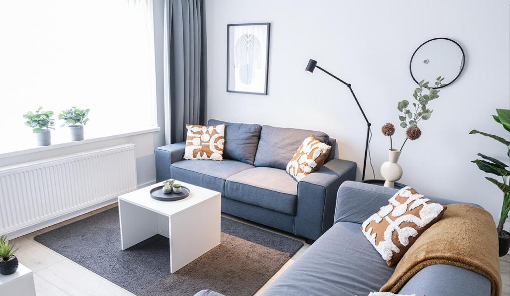 a living room with a couch and a table at 6p newly renovated home with unique roof-terrace in Strijp