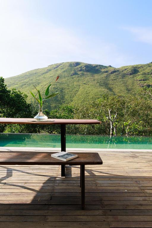 a wooden table with a plant on top of it at Marmaram Heritage in Vagamon
