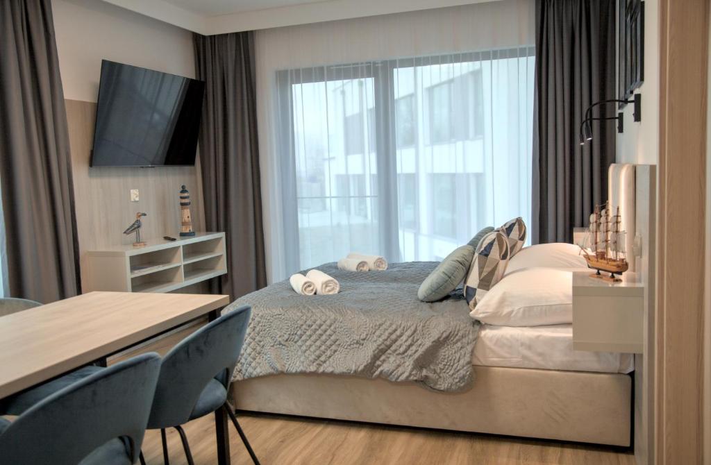 Postel nebo postele na pokoji v ubytování Hotel i Apartamenty Gorzelanny Dźwirzyno