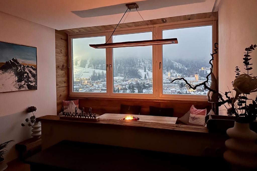 a window with a candle in a room with a view at Alpenblick - klein, aber fein in Schladming