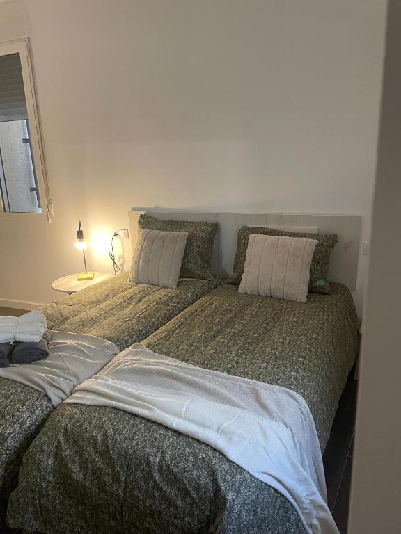 a bedroom with two beds with pillows on them at La Pitxotxa - Apartamento in Novelda