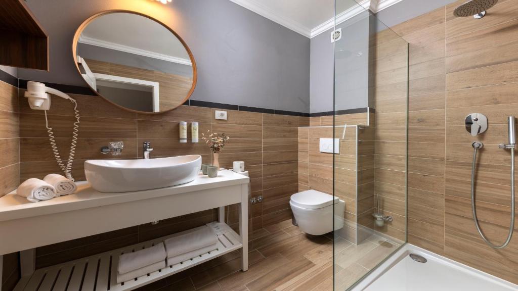 a bathroom with a sink and a shower at Eola Leisure Rooms in Stara Baška
