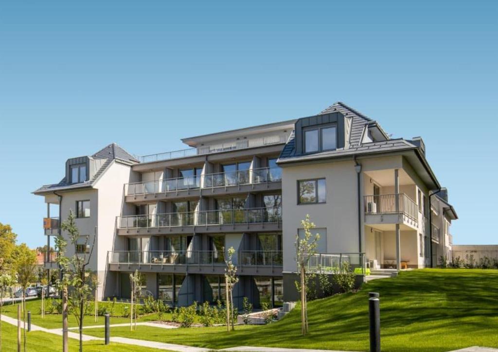 an apartment building with a lawn in front of it at Edison Villa 209 Fonyód in Fonyód