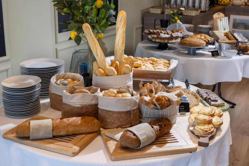 a table with various pastries and breads on it at Eola Leisure Rooms in Stara Baška