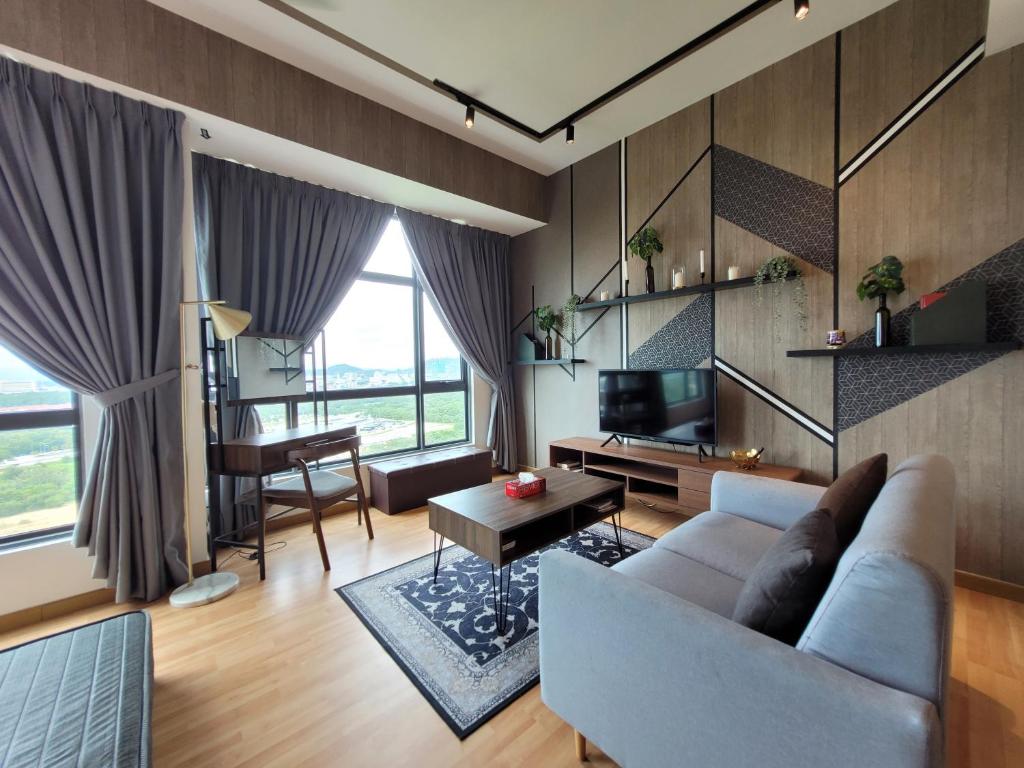 a living room with a couch and a table at Umi Studio Imperium Residence in Telok Baru