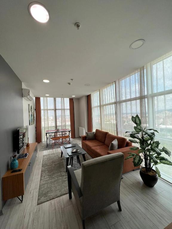 a living room with a couch and a table at ZİN D Home Dudullu Suit Otel in Istanbul