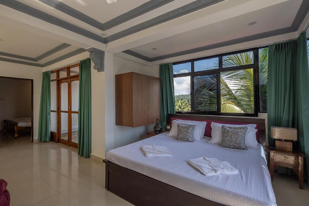 Postel nebo postele na pokoji v ubytování Broad Bean Royal Resort Goa