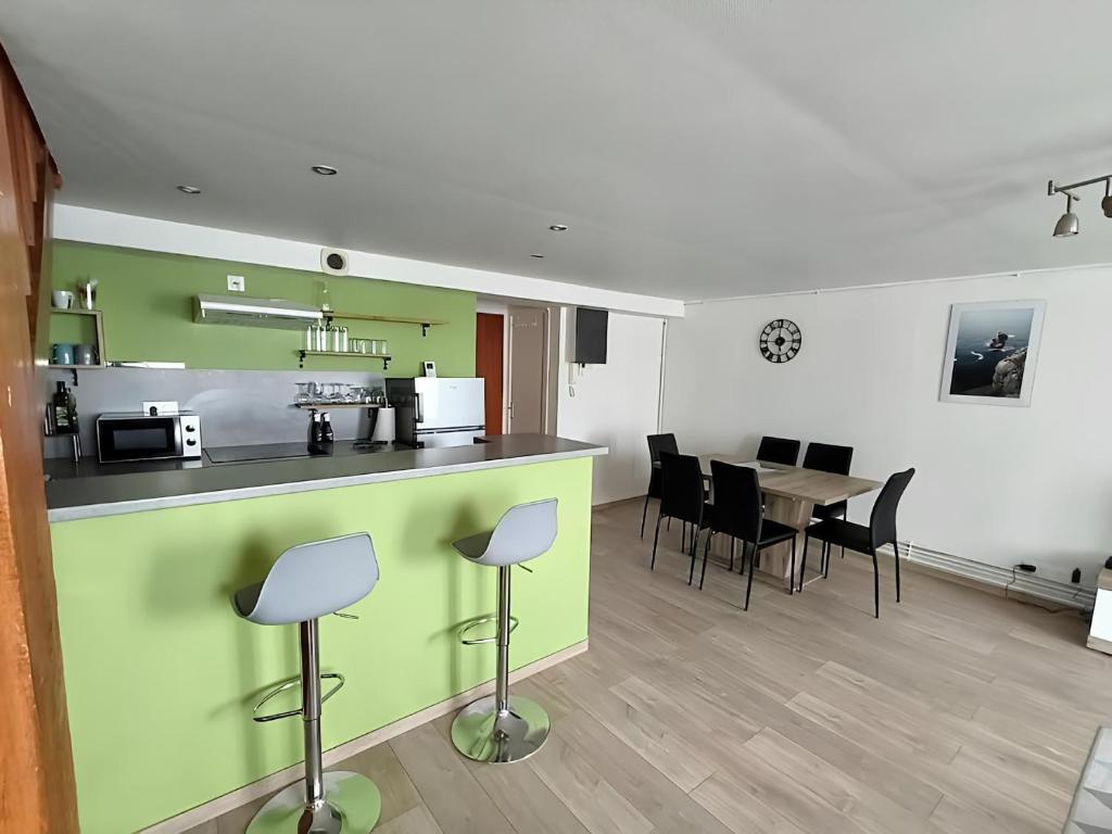 une cuisine et une salle à manger avec une table et des chaises dans l'établissement Stanislas, à Rouen