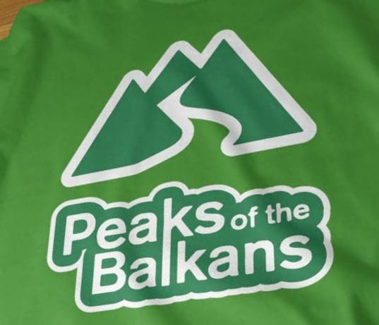 a green bag with the peaks of the bakans on it at Dedushi Guesthouse &Wood cabins-Camping place in Gusinje