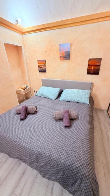 a bedroom with a large bed with two pillows on it at La Grotta dell'Orso in Aosta