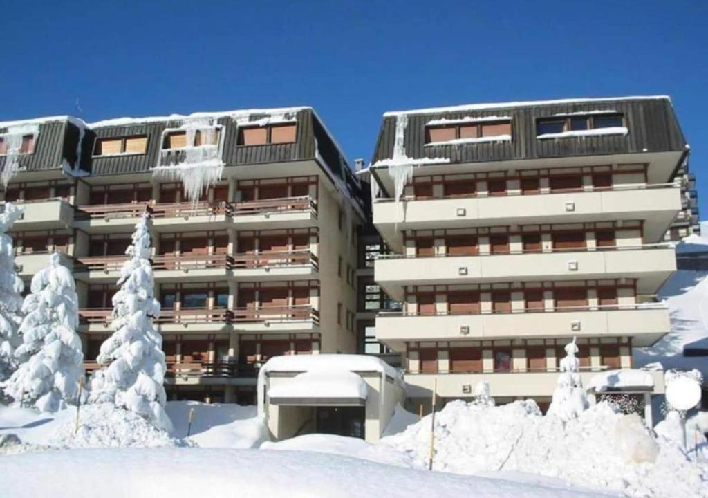 a large building with snow in front of it at Sestriere Gem Comfy Apartment with Ski Views in Sestriere