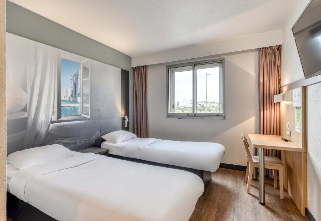 Postel nebo postele na pokoji v ubytování B&B HOTEL Montpellier Vendargues