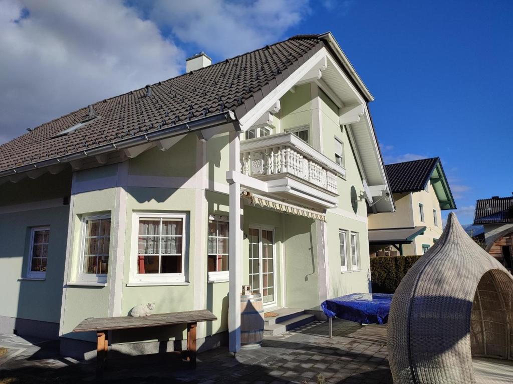 a house with a bench in front of it at Ferienhaus Aich by Alpenidyll Apartments in Gössenberg