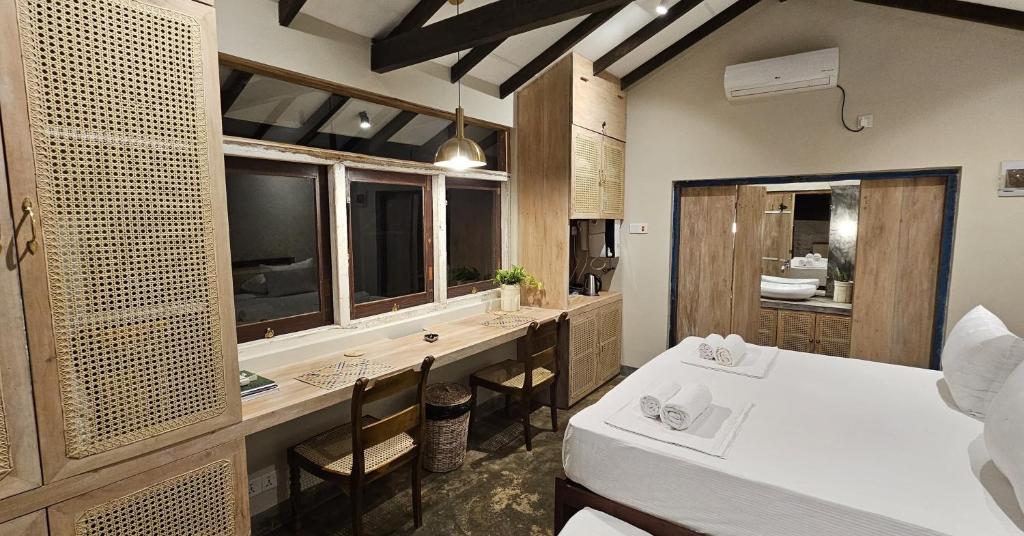 a bathroom with a sink and a vanity with a counter at Cinta Hiriketiya in Dickwella