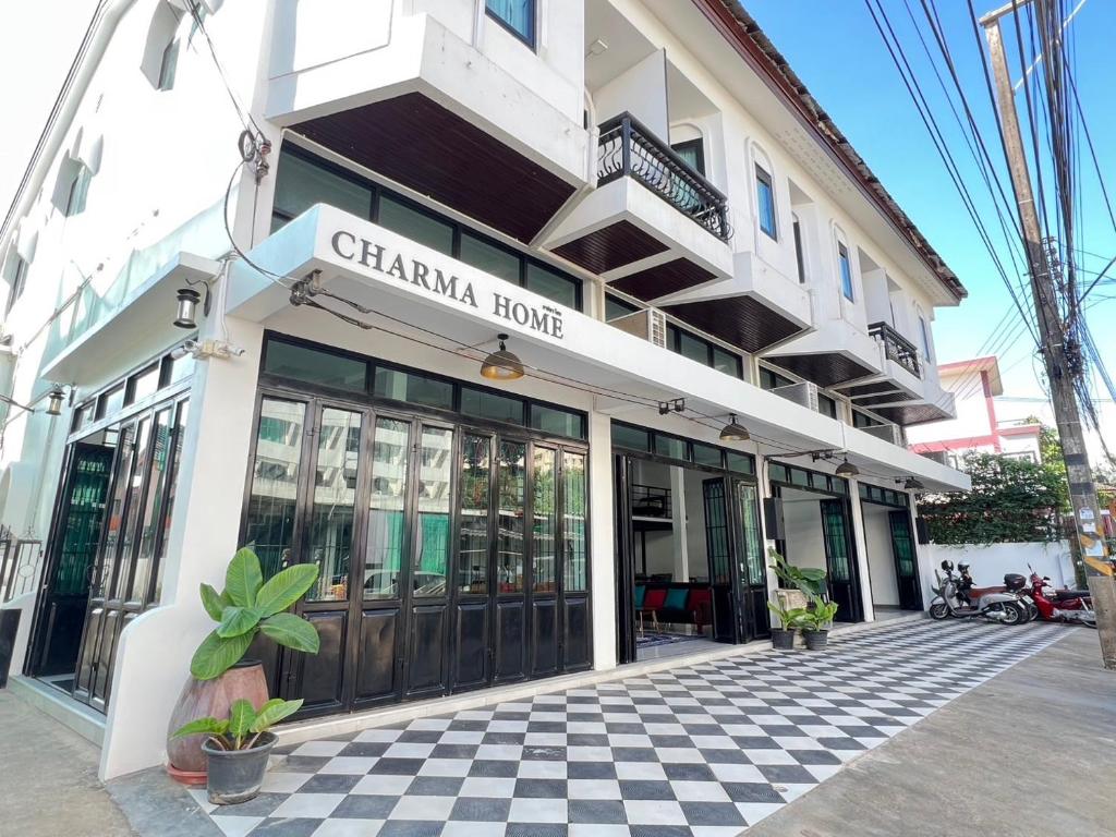 a building with a china house on the street at Charma Home Watket in Chiang Mai
