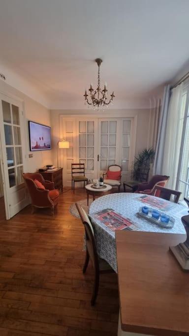 - un salon avec une table et un canapé dans l'établissement Appartement Cosy Paris 15e, à Paris