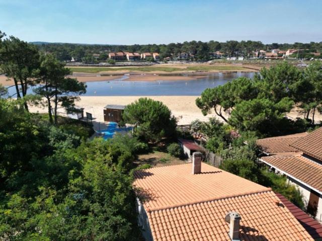 a view of a river and a beach with trees at Villa les Rameurs in Mimizan-Plage