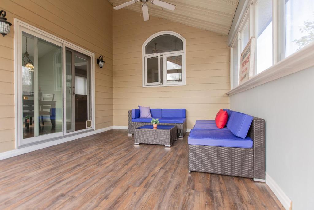 a screened porch with two chairs and a table at Barrie Bliss 3BR Haven near Centennial Beach in Barrie