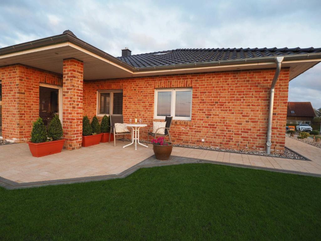 a brick house with a patio and a table at Panorama in Ravensberg