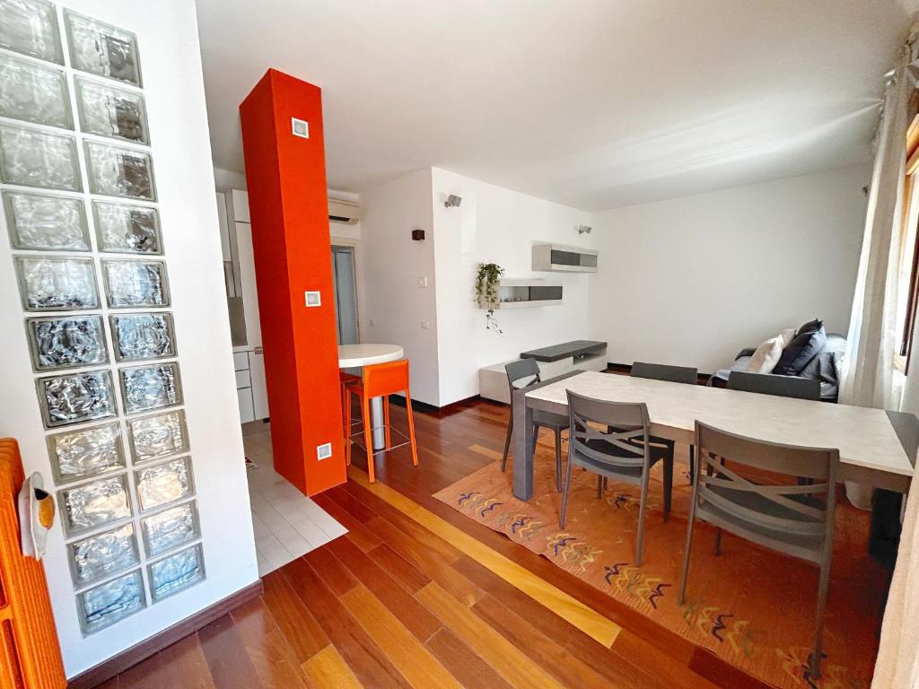 a living room and dining room with a table and chairs at Orange apartment in Zelarino