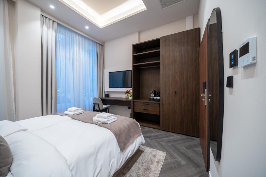 Postel nebo postele na pokoji v ubytování Damas Suites Budapest