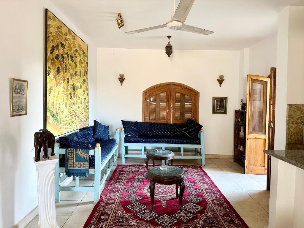 a living room with a couch and a table at Sunset Haven in Luxor