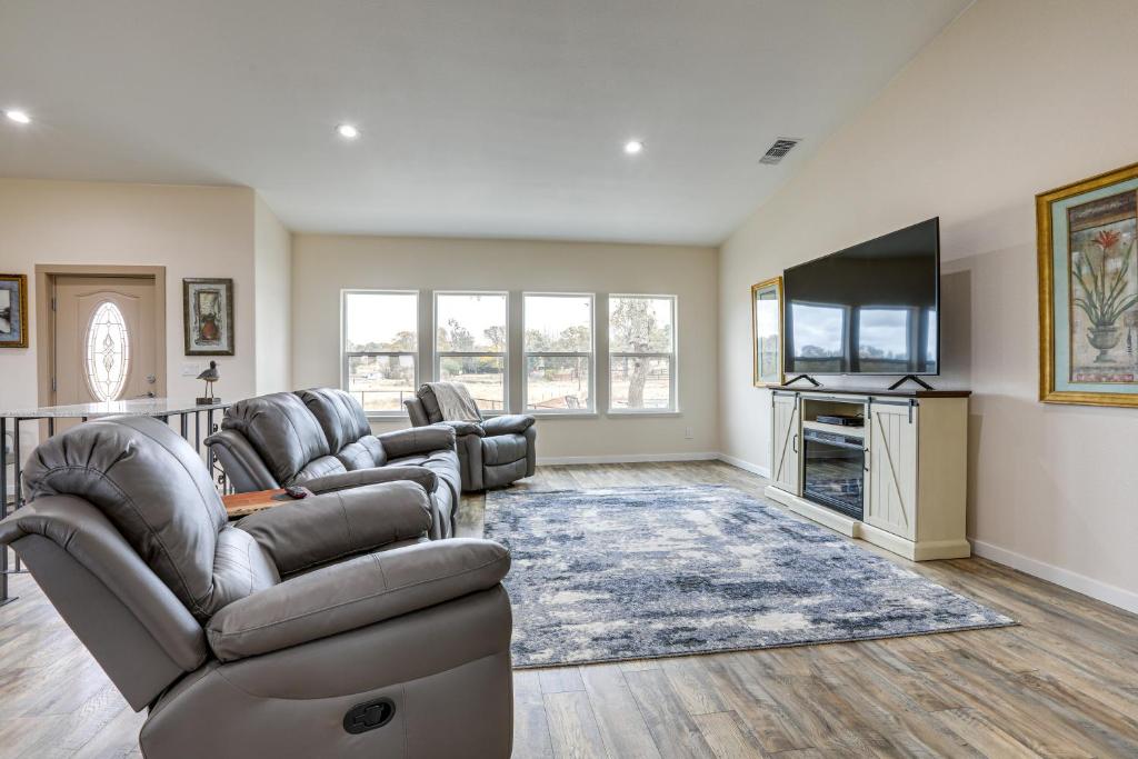 a living room with leather furniture and a flat screen tv at On-Site Winery Rural Plymouth Getaway! in Plymouth