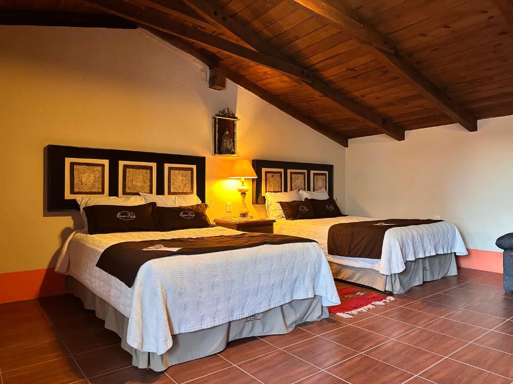 Postel nebo postele na pokoji v ubytování Santa Elena Hotel Boutique