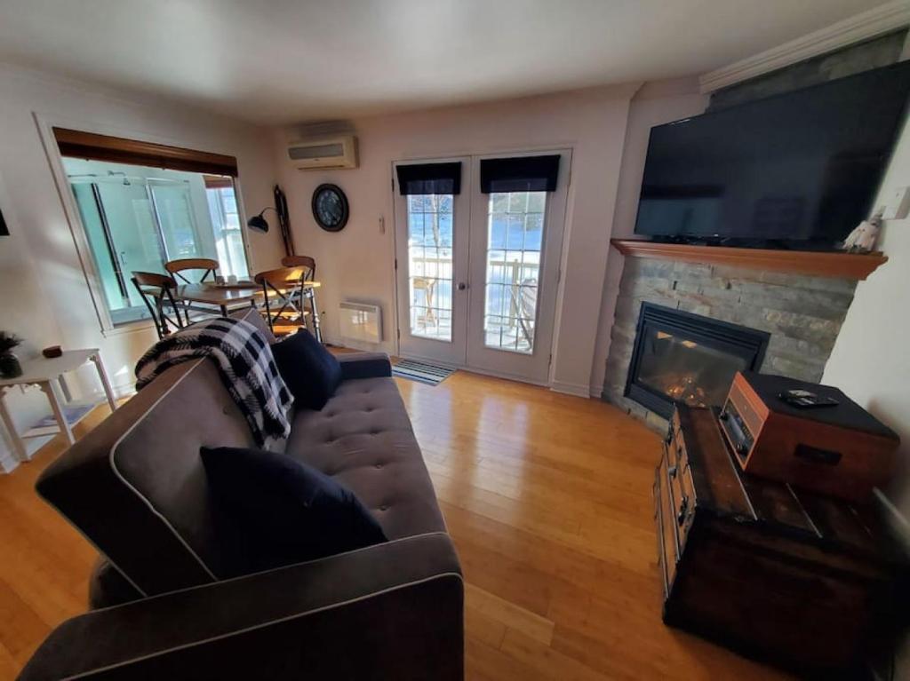 a living room with a couch and a fireplace at Studio Rustico Chic Nearby Piedmonts Hotspots in Piedmont