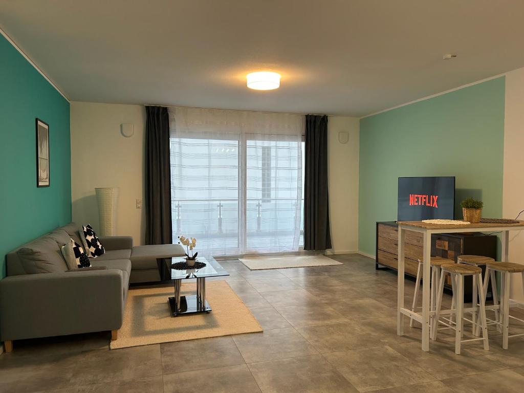 a living room with a couch and a table at Zentrale Lage Netflix in Bruchsal