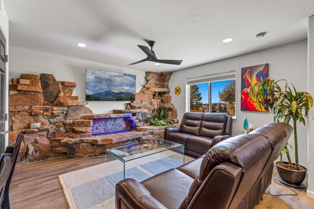 a living room with a couch and a stone fireplace at Decorated for the Holidays! 2BDR Home in Downtown Flagstaff in Flagstaff