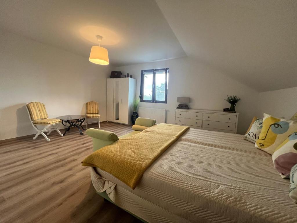 a bedroom with a large bed and a table at Vöslau Panorama near Vienna in Bad Vöslau