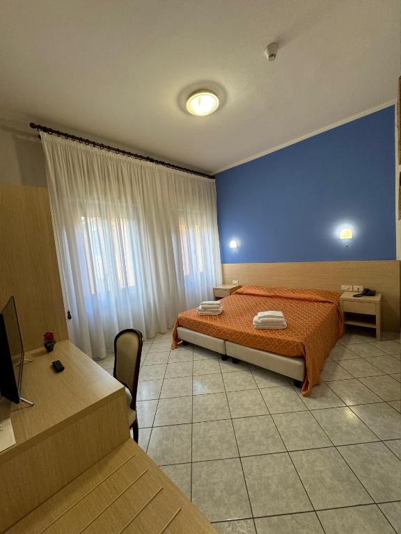 Postel nebo postele na pokoji v ubytování Albergo La Posta Arezzo