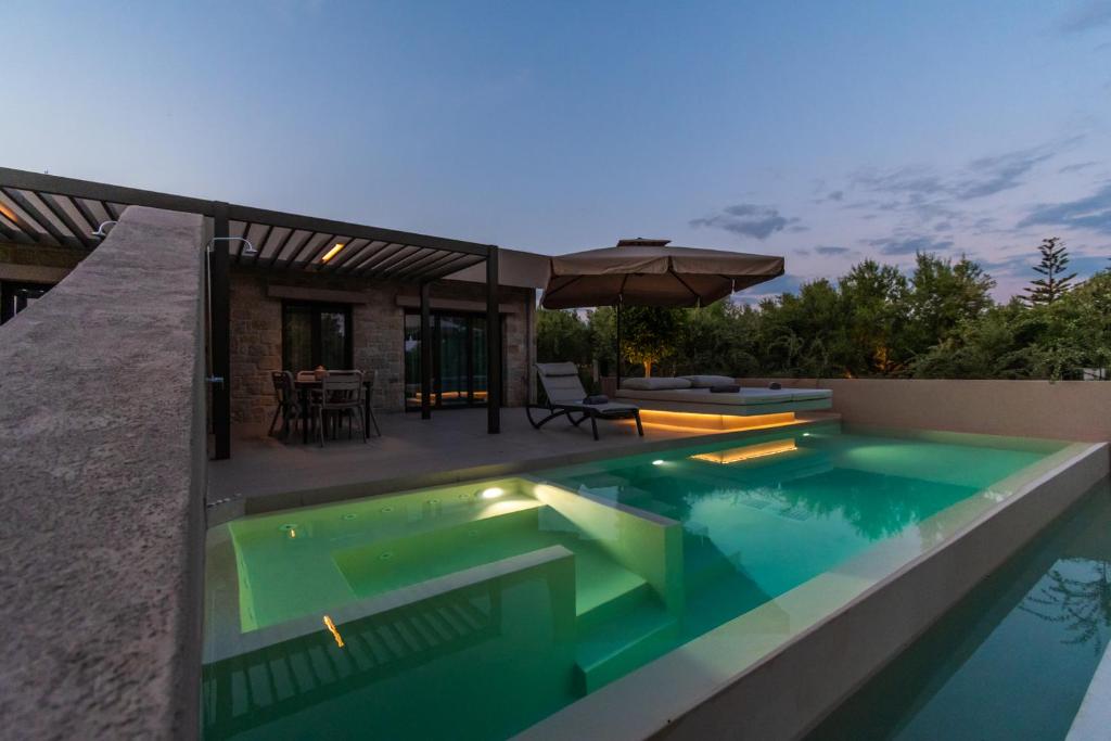a swimming pool in the backyard of a house at Nestor Luxury Villas in Romanu