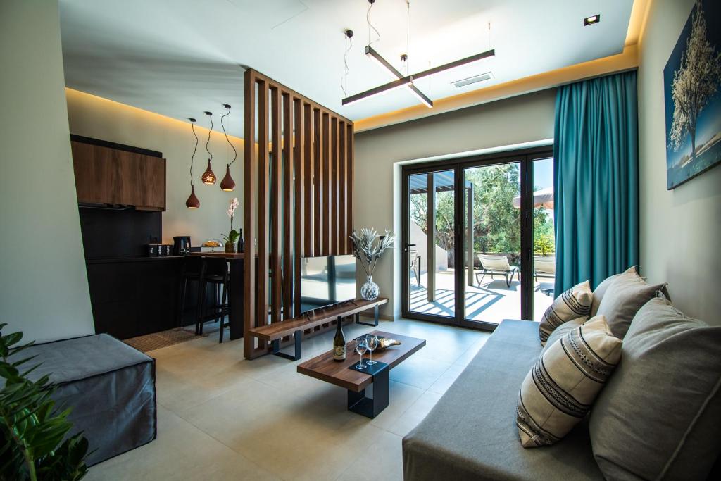 a living room with a couch and a table at Nestor Luxury Villas in Romanu
