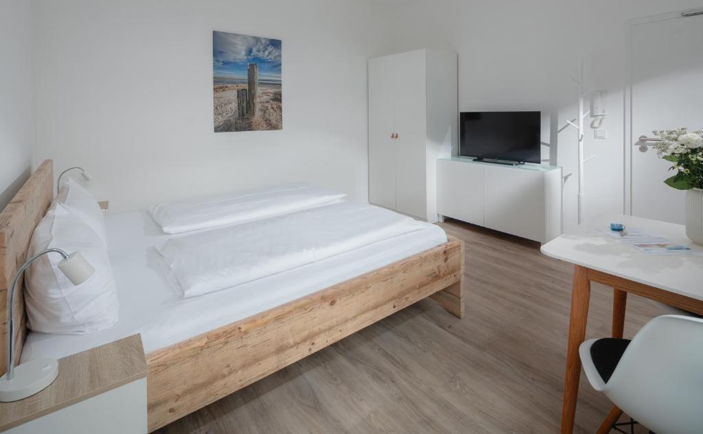 Postel nebo postele na pokoji v ubytování Strandloft VIER Norderney