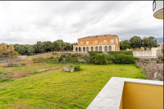 a large building on top of a green field at Dimora Borbonica in Ercolano