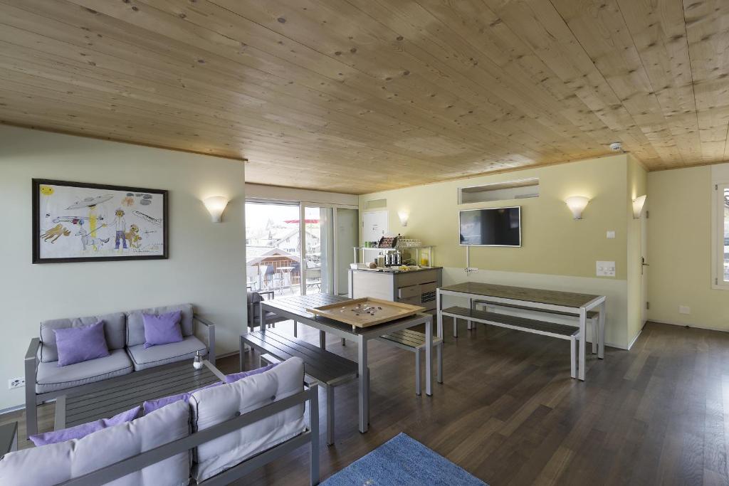a living room with a couch and a table at Alplodge in Interlaken