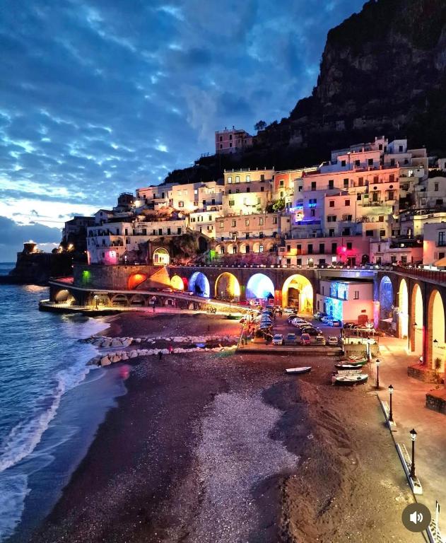 a group of buildings on a beach at night at Lo scorcio del Borgo in Atrani