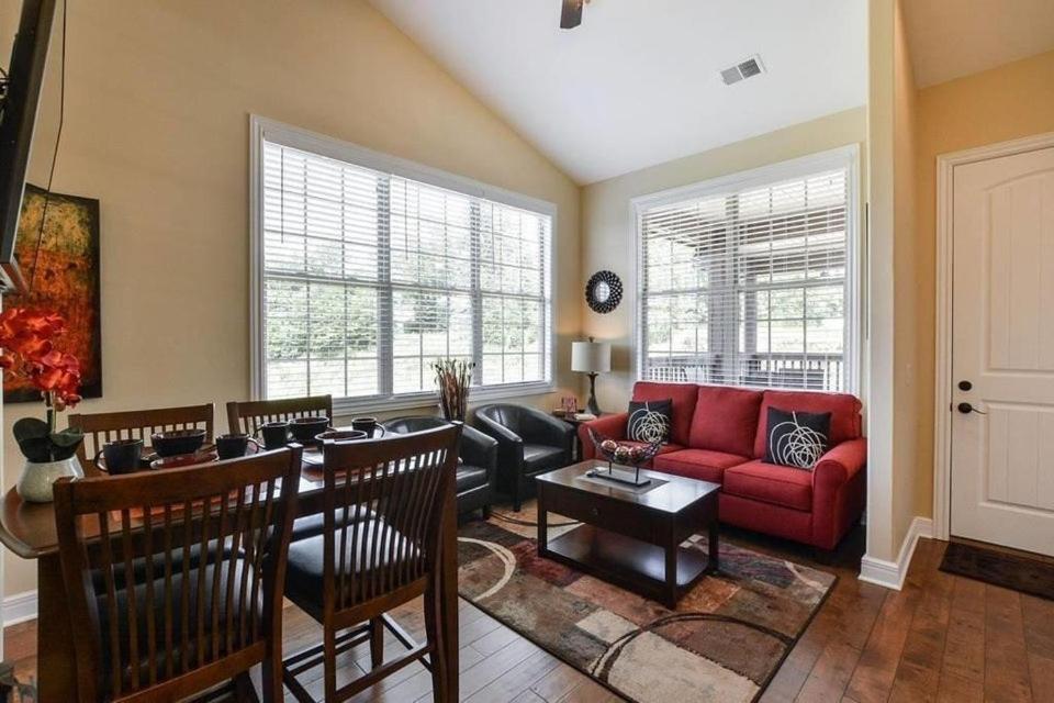 a living room with a red couch and a table at Penthouse Lakeview Haven in Branson