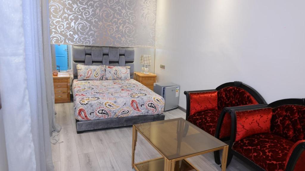 Postel nebo postele na pokoji v ubytování Riad Sevilla