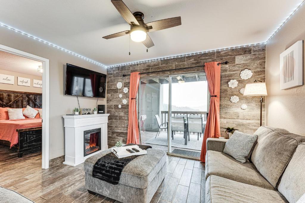 a living room with a couch and a fireplace at 1 Mi to Silver Dollar City! Lake-View Family Haven in Branson