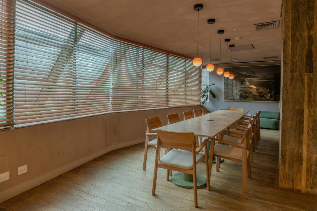 a dining room with a long table and chairs at The Charlee Hotel in Medellín
