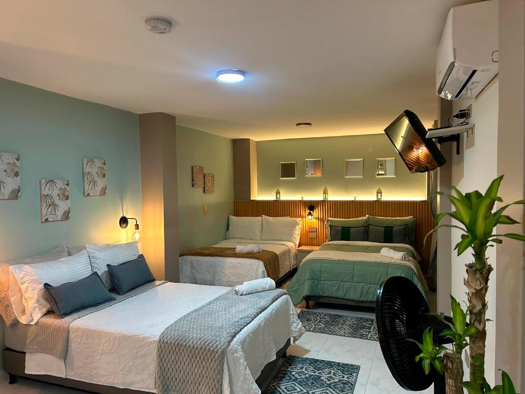 Postel nebo postele na pokoji v ubytování Provenza Medellin Hotel Boutique