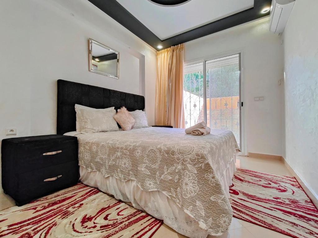 a bedroom with a large bed and a window at Tangier Center Free Parking in Tangier