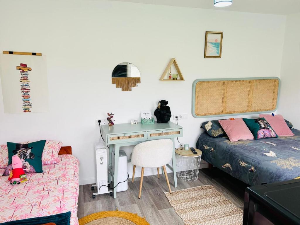 a bedroom with a bed and a desk at CasaZaPatos Bungalows in Nigrán