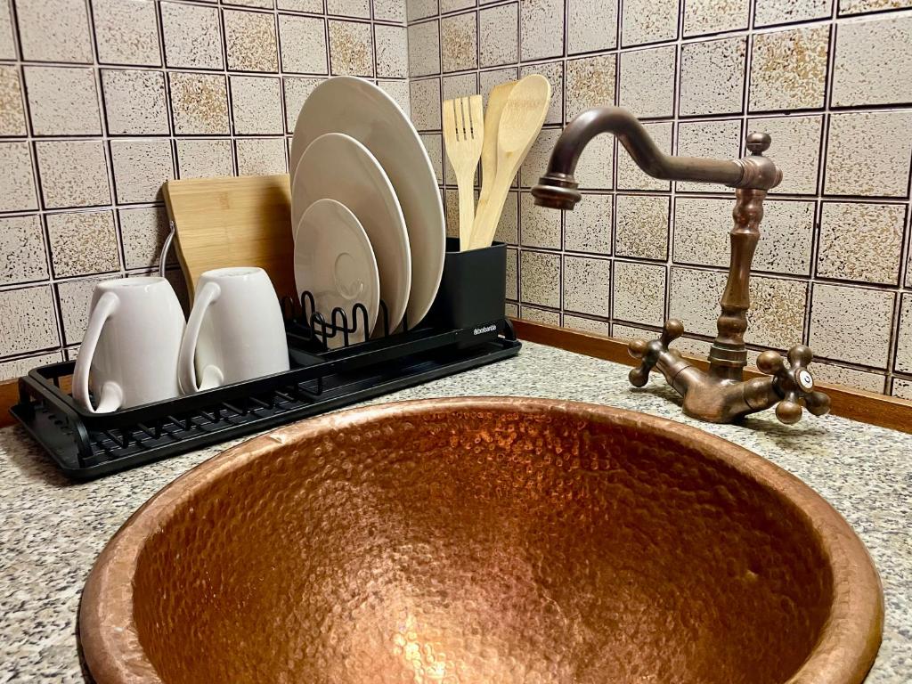 a kitchen sink with a tray with plates and utensils at Lake Front View on Viale GENO in Como