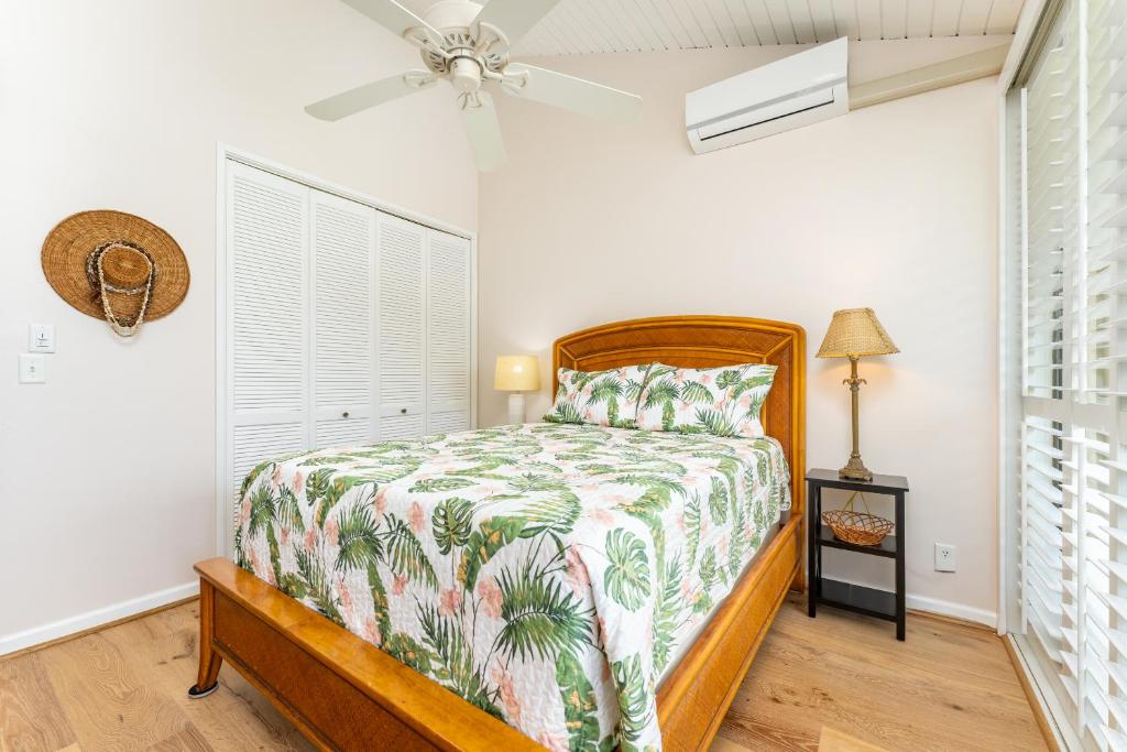a bedroom with a bed and a ceiling fan at Beautiful Kuilima East Estates Townhome - Golf Course & Ocean Views in Kahuku